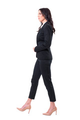Side view of serious confident successful business woman manager walking. Full body isolated on white background.
