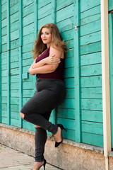 Young stylish woman walking in the city street. Spring fashion outfit, elegant look. Plus size model.