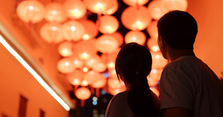 Couple look at the red lantern together © leungchopan