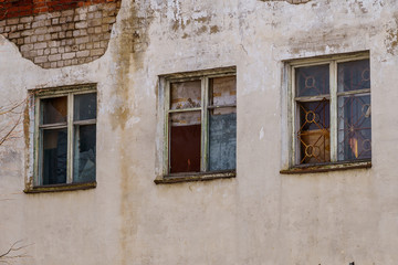 windows in a brick house with a bare facade