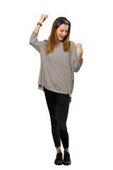 Obraz premium A full-length shot of a Young woman with headscarf celebrating a victory over isolated white background