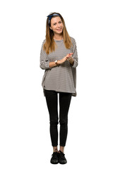 A full-length shot of a Young woman with headscarf applauding after presentation in a conference over isolated white background