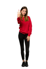 Obraz na płótnie Canvas A full-length shot of a Young woman with red sweater happy and counting three with fingers over isolated white background