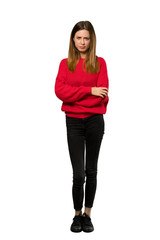 A full-length shot of a Young woman with red sweater feeling upset over isolated white background