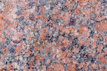 Natural mountain red granite background with impregnation of minerals