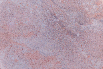 Natural mountain red granite background with impregnation of minerals