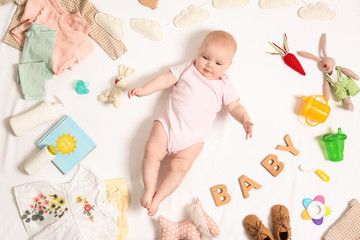 Cute little baby with clothing and accessories on white background, top view