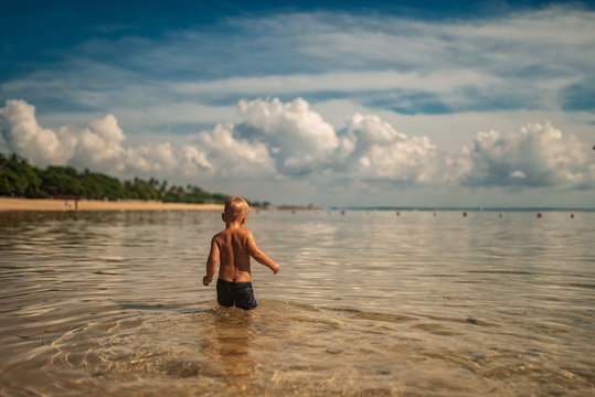 amazig landscape with white baby sea water on background of blue sky with powerful clouds in Bali