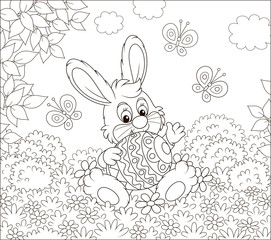 Little Easter Bunny sitting with a colorfully decorated big egg among flowers and flittering butterflies on a lawn on a sunny spring day, black and white vector illustration in a cartoon style