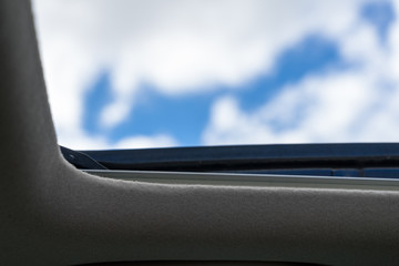 car Sunroof looking at blue sky