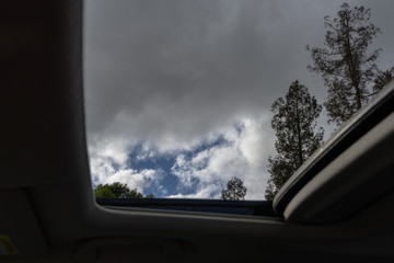 car Sunroof looking at blue sky