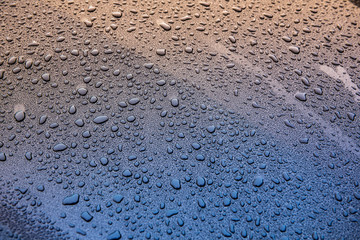raindrops on blue glass surface