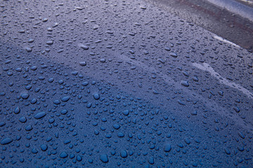raindrops on blue glass surface