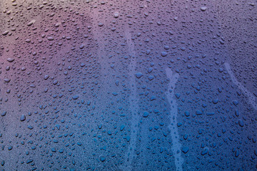 raindrops on blue glass surface