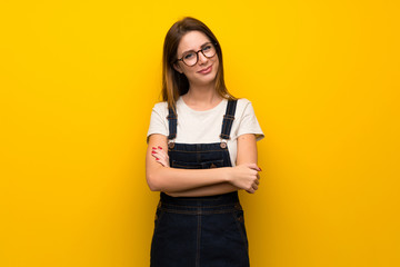 Woman over yellow wall smiling
