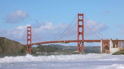 Huge waves crashing under the Golden Gate Bridge in San Francisco, seen from Baker Beach. Shot at 60 fps