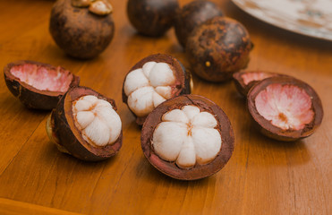 stiil life with exotic fruits mangosteen on the wood table in tropical garden in Bali
