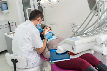 Doctor showing to patient teeth problems in mirror