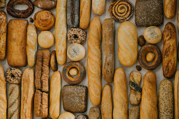 different fresh bread on the shelves in bakery. Selective focus