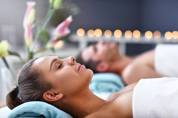 Adult happy couple relaxing in spa salon