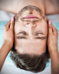 Handsome man having massage in spa salon