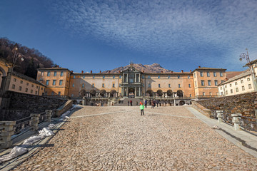 Panoramic view of the inner courtyard of the seventeenth-century monumental complex dedicated to the Virgin Mary, of the Sanctuary of Oropa in Piedmont, Italy.