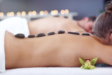 Adult happy couple relaxing in spa salon