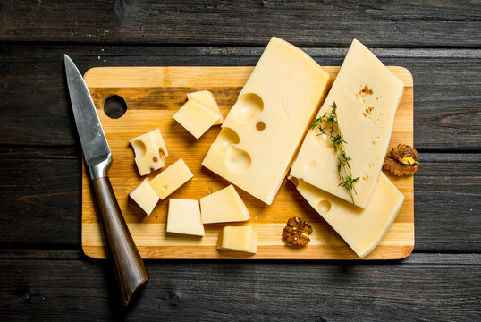 Fresh cheese with nuts on a wooden Board.