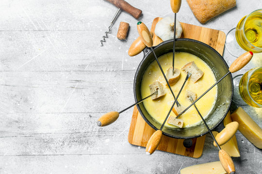Delicious fondue cheese with bread and white wine