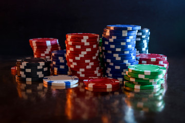 Colorful casino chips on table close up