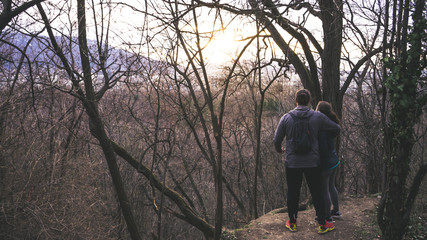 couple hugging looking the sunset in a park of Sofia Bulgaria, enjoying the sun in winter