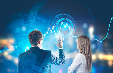 Businessman and businesswoman working with graph