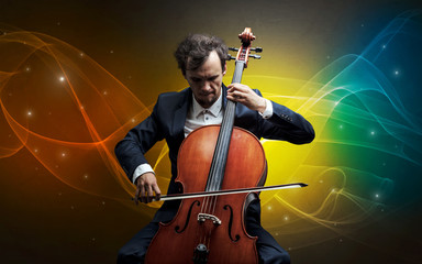 Fototapeta premium Serious classical cellist with fabled sparkling wallpaper