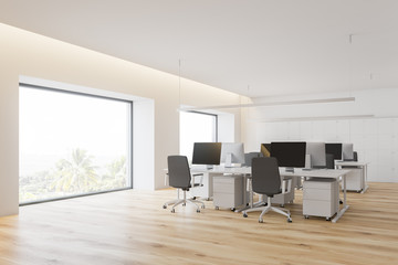 Corner of open space office with windows