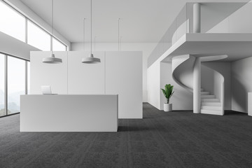 Interior of white office with reception and stairs