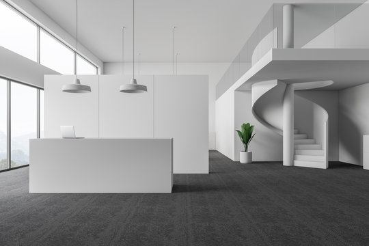 Interior of white office with reception and stairs