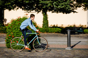 Young man biking in city park