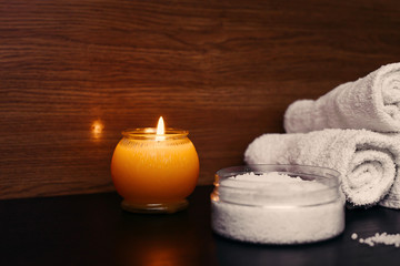 spa setting with candles and white towel