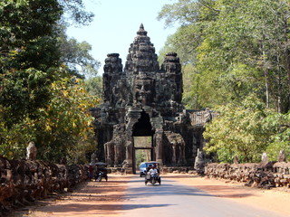Beautiful view of the Victory Gate of Angkor Thom and a rickshaw with tourists