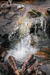 Stones in running water in a mountain river stream