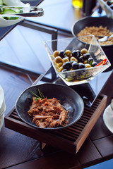 Breakfast selection of food in hotel with olives and tuna on plates