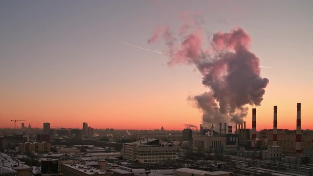Time lapse panoramic shot of Moscow city at colourfully red sunset. The worldwide concept of pollution of megalopolises and global warming. Panoramic shot