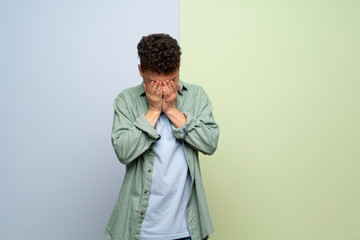 Obraz premium Young man over blue and green background with tired and sick expression