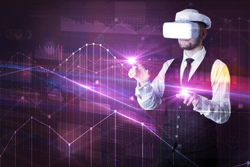 Businessman with virtual reality goggles organizing 3D graphs charts and financial variables
