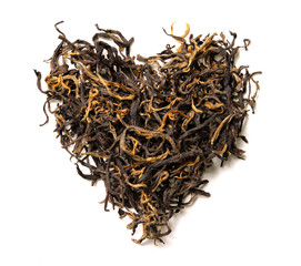 Heart shaped from black tea isolated on white background. Top view. Close up. High resolution