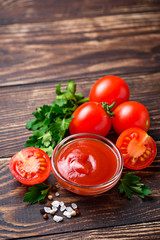 Tomato ketchup sauce on wooden background