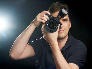 Male photographer taking a picture straight ahead of you