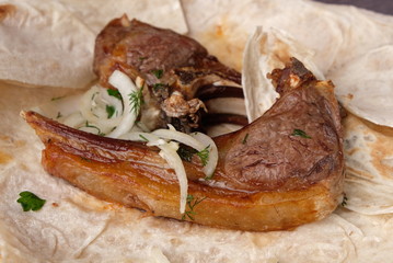 grilled lamb meat on a pita bread, close-up