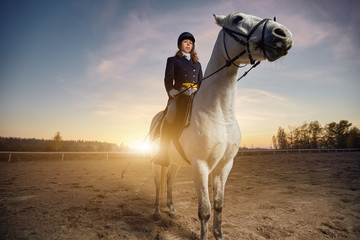 Woman wearing dressage costume riding a horse