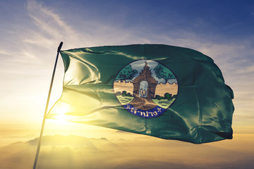 Naklejka premium Lampang province of Thailand flag waving on the top sunrise mist fog